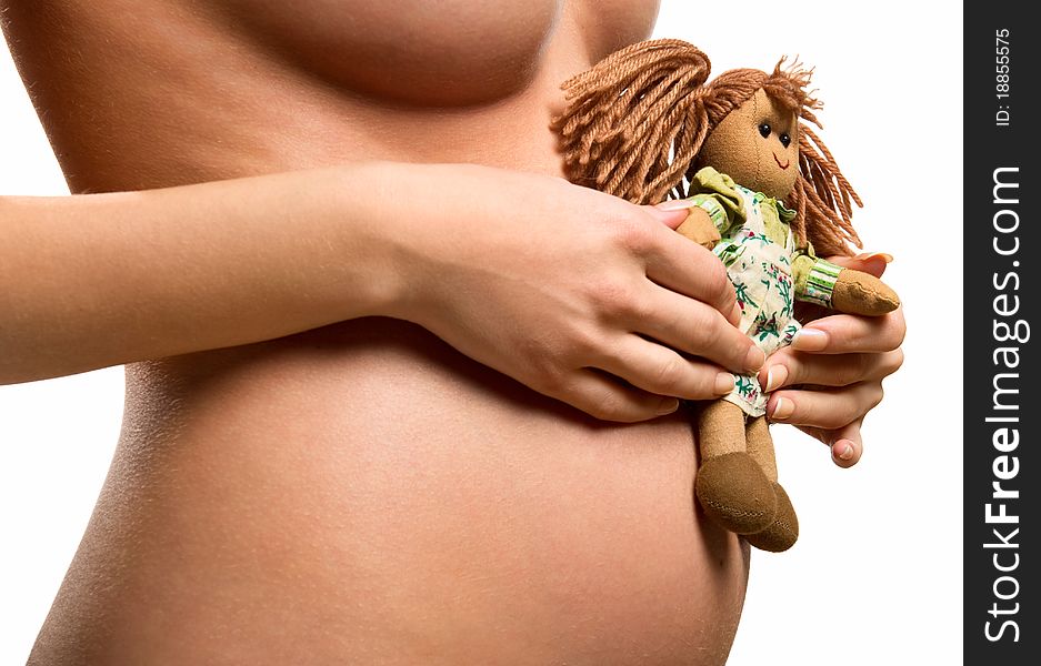 Pregnant woman holding a doll. Pregnant woman holding a doll