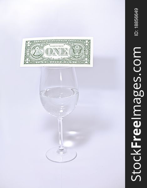 Dollar and wine glass isolated on white background