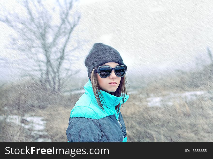 Beautiful girl in sunglasses and winter