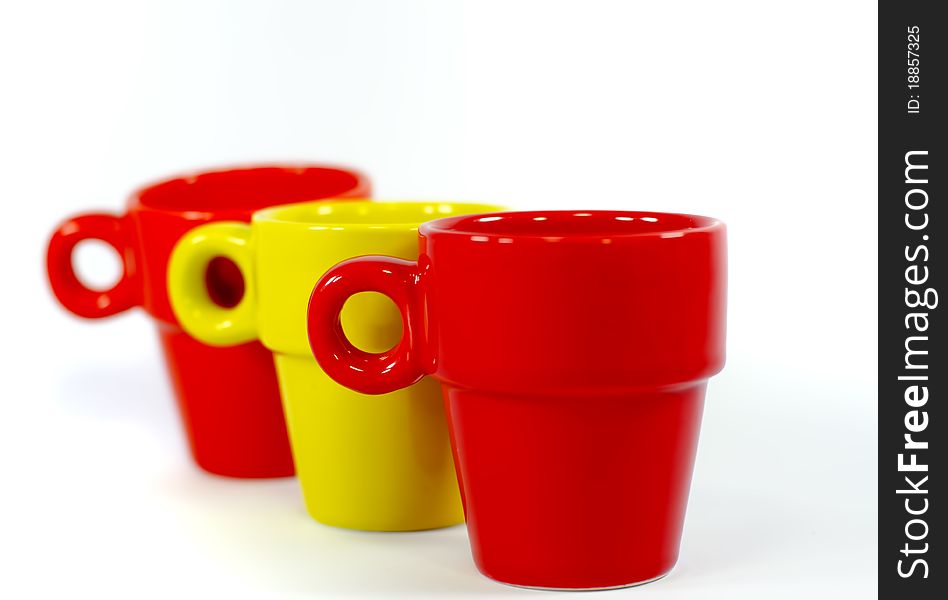 Three colored coffee cups on white background