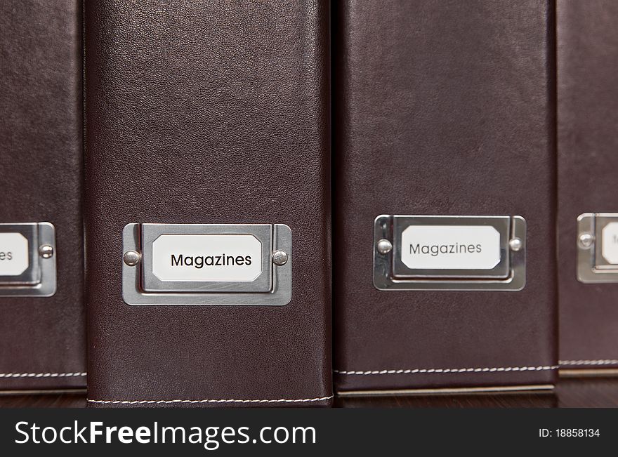 Brown leather magazine holders in a row.