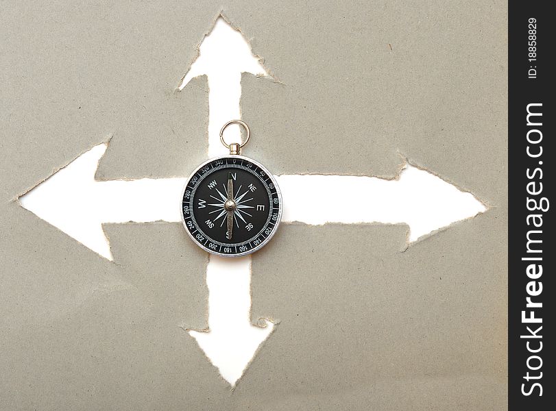 Compass and arrow cut in cardboard. Compass and arrow cut in cardboard