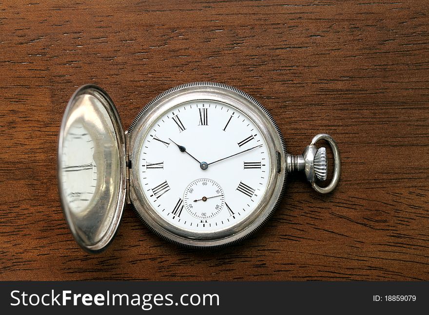 Pocket watch on wooden table