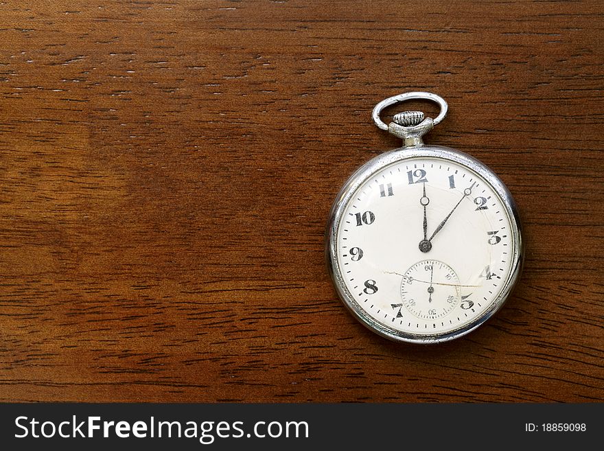 Pocket watch on wood board