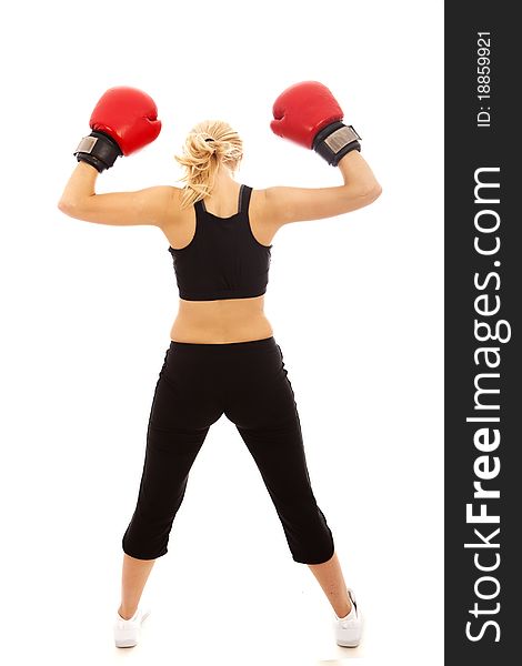 A female wearing red boxing gloves holding her arms in the air. A female wearing red boxing gloves holding her arms in the air