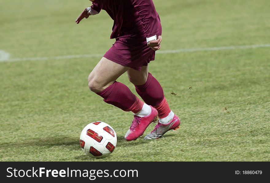 Soccer players running after the ball