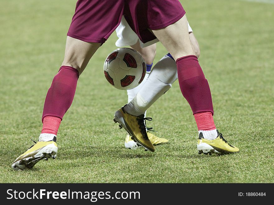 Soccer players running after the ball