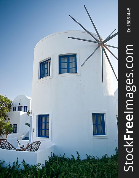 White Windmill with blue Windows in GreeceWhite. White Windmill with blue Windows in GreeceWhite