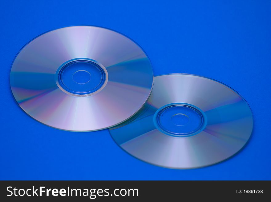 Tvo CDs on blue backrgound.