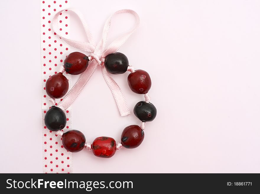 Hand painted beads bracelet on fabric and white background. Hand painted beads bracelet on fabric and white background