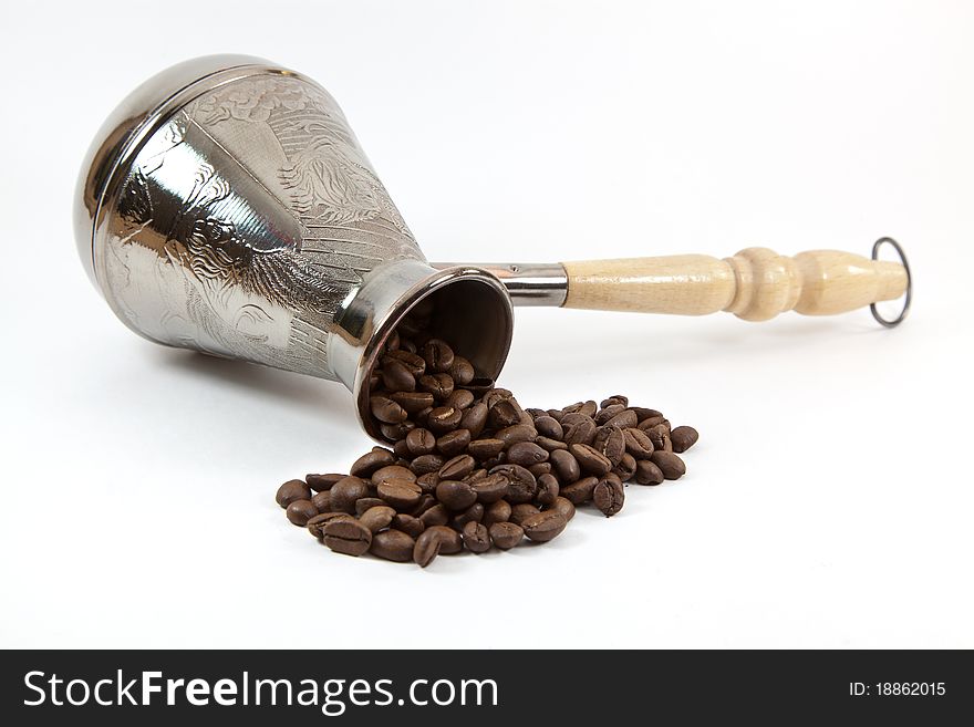 Coffee maker with coffee beans on white background