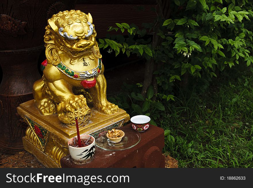 Gold Lion Shrine with sacrificial offering