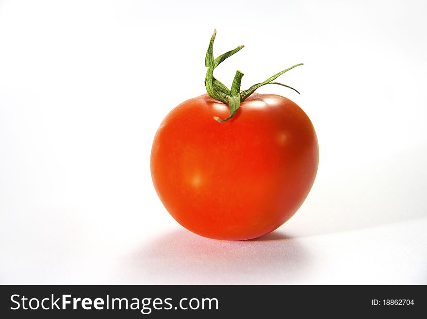 Single tomato isolated on white background. Single tomato isolated on white background.