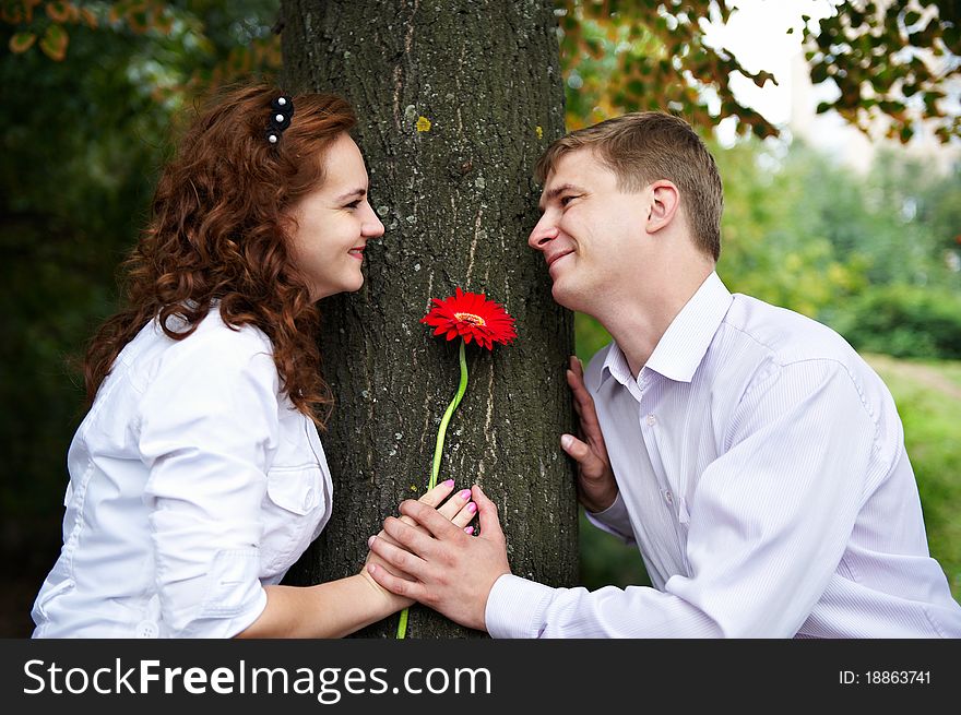 Romantic date on a date in park with red flower