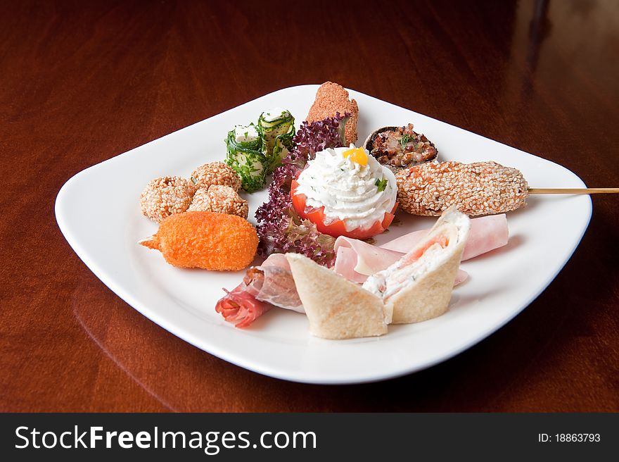 Various food items on a white plate. Various food items on a white plate