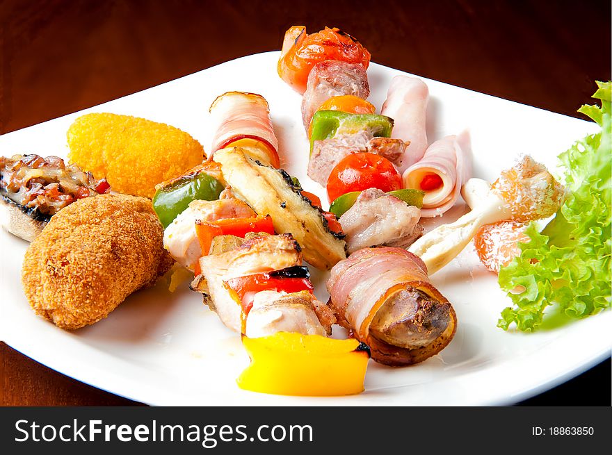 Various food items on a white plate. Various food items on a white plate