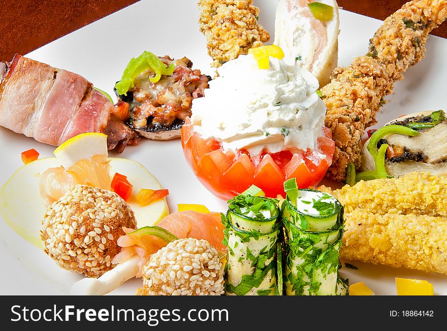 Various food items on a white plate. Various food items on a white plate