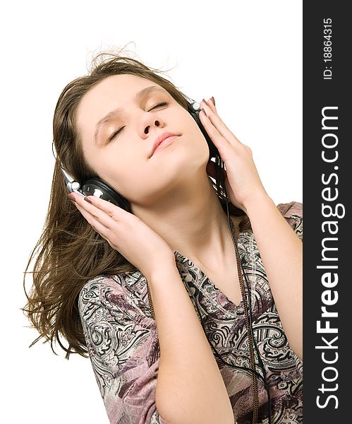 Teenage girl listening music on a white background