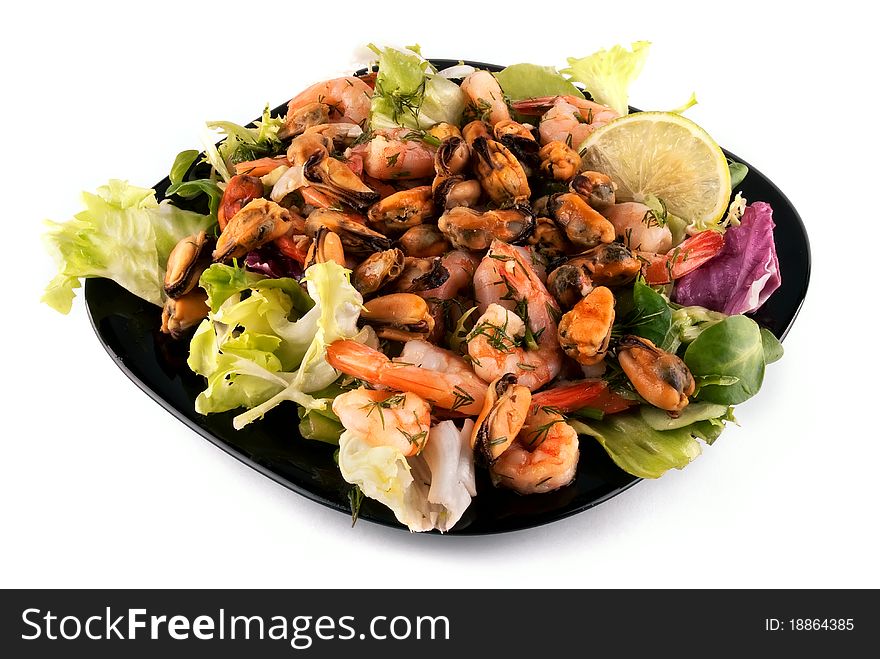 A photo of salad with seafood and lettuce on a black plate. A photo of salad with seafood and lettuce on a black plate.