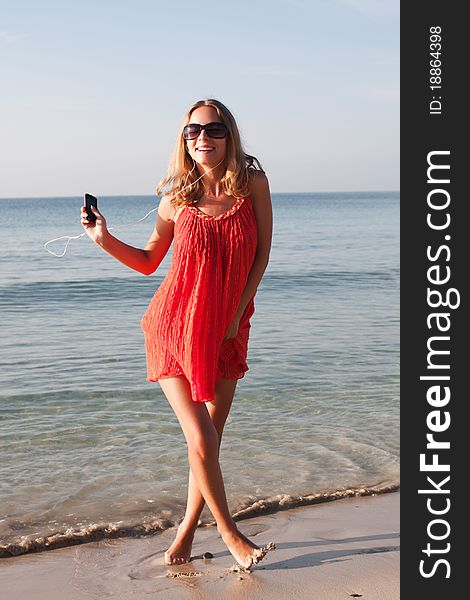 Beautiful young woman dancing on the beach. Beautiful young woman dancing on the beach