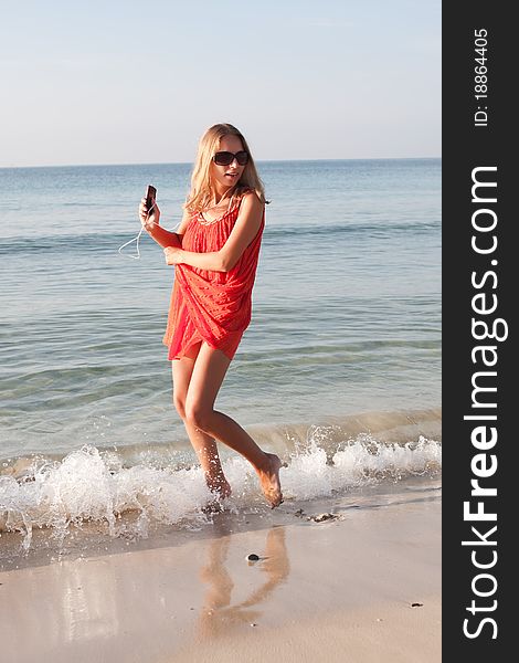 Beautiful young woman dancing on the beach. Beautiful young woman dancing on the beach