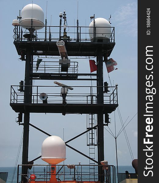A ship's mast with an array of aerials and domes.
