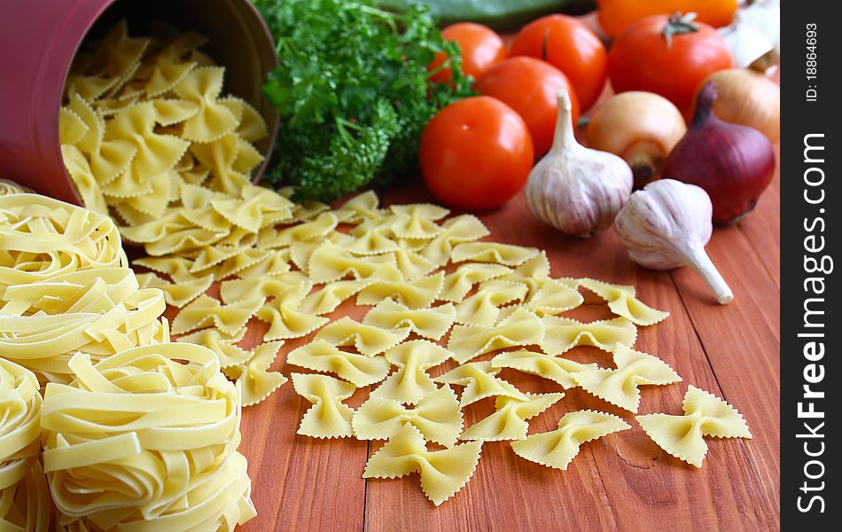 Italian pasta and fresh vegetables on the kitchen table. Italian pasta and fresh vegetables on the kitchen table.