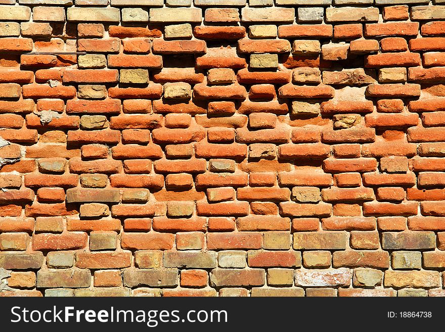 A fragment of the old wall of red brick. A fragment of the old wall of red brick