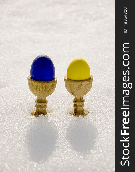 Two color Easter eggs on spring snow background. Two color Easter eggs on spring snow background