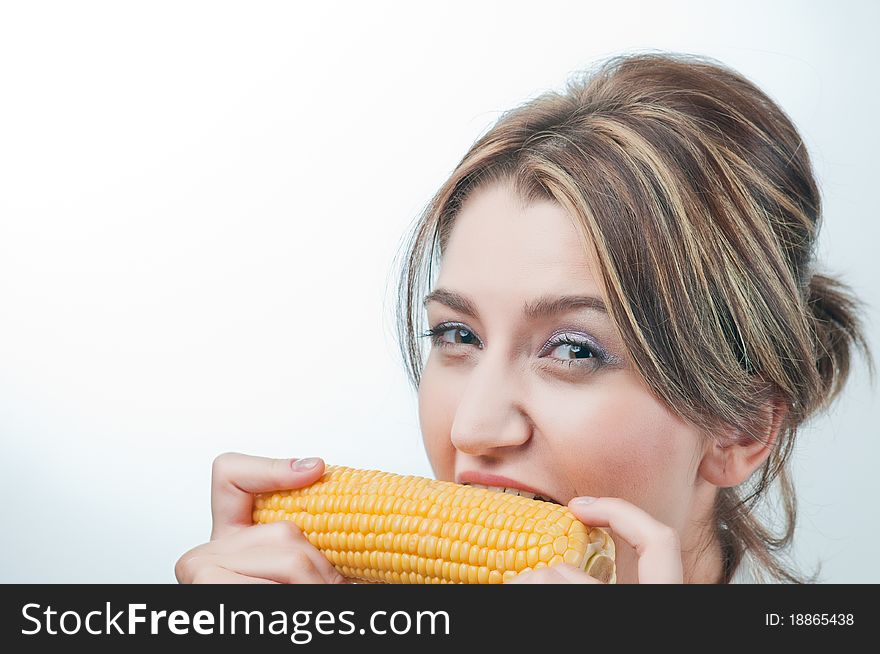 Beautiful girl's face. Healthy eating yellow corn vegetable. Beautiful girl's face. Healthy eating yellow corn vegetable