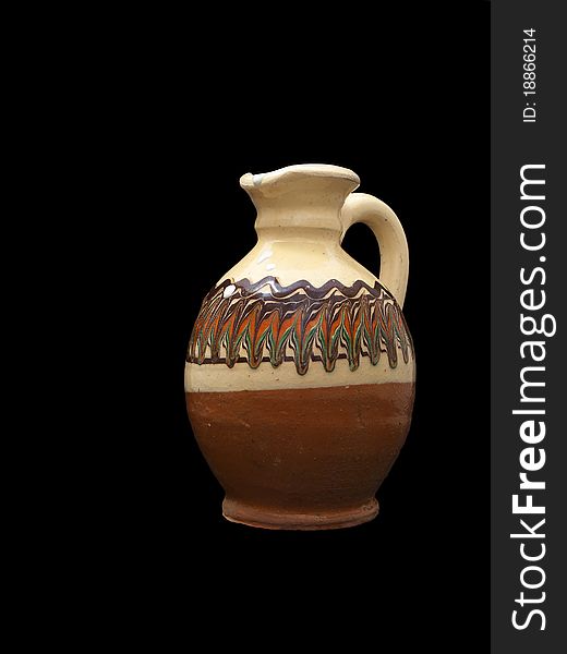 Clay pitcher with milk isolated on black background