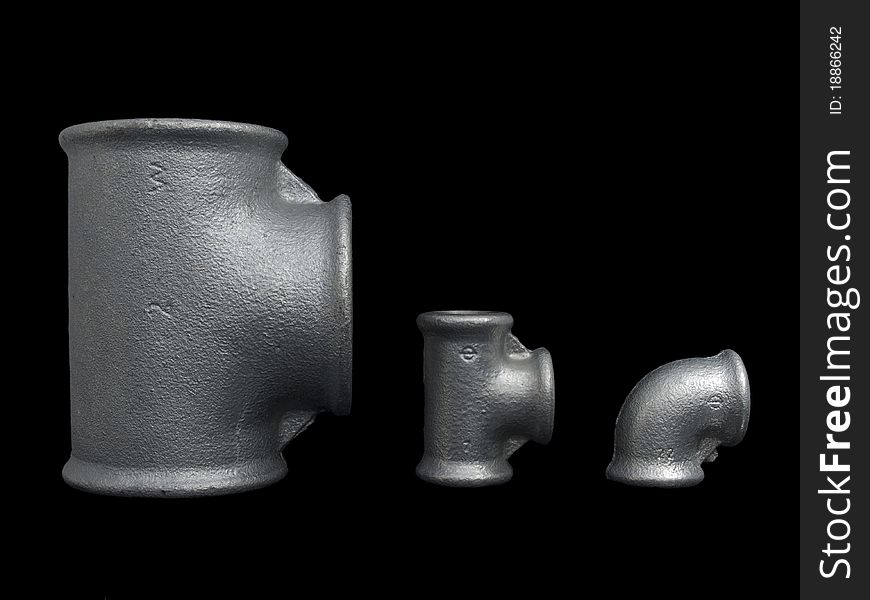 Different size of plumbing zinc coated fittings isolated on pure black background