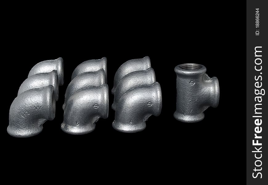 Different size of plumbing zinc coated fittings isolated on pure black background