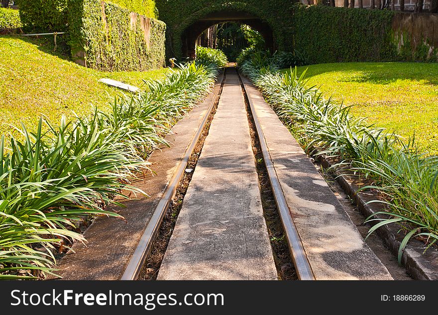 Train rail track in green park to tunnel. Train rail track in green park to tunnel