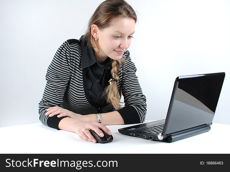 Young successful woman working at desk with laptop