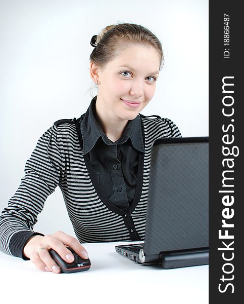 Young successful woman working at desk with laptop