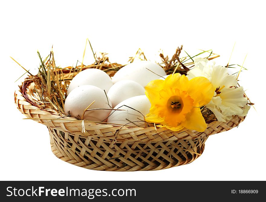 Eggs in a wicker basket isolated