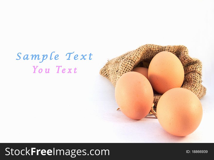 Brown eggs in canvas sack isolated on a white background