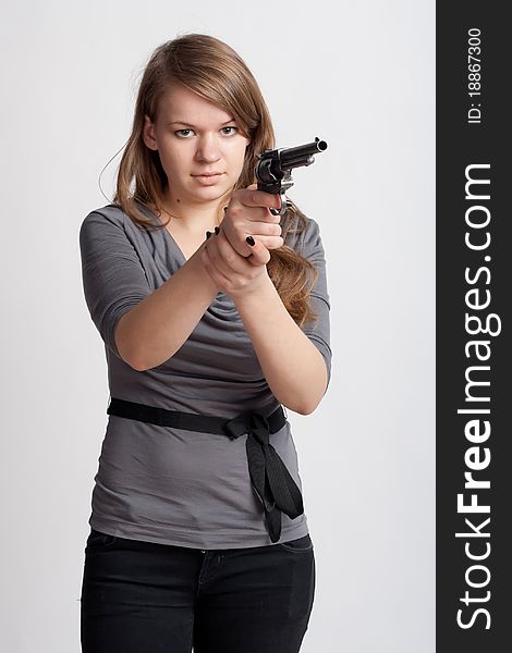 Girl with a gun on a light background. Girl with a gun on a light background