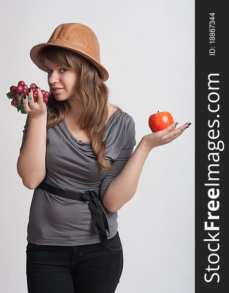 Girl With Grapes And Apples In The Hands Of