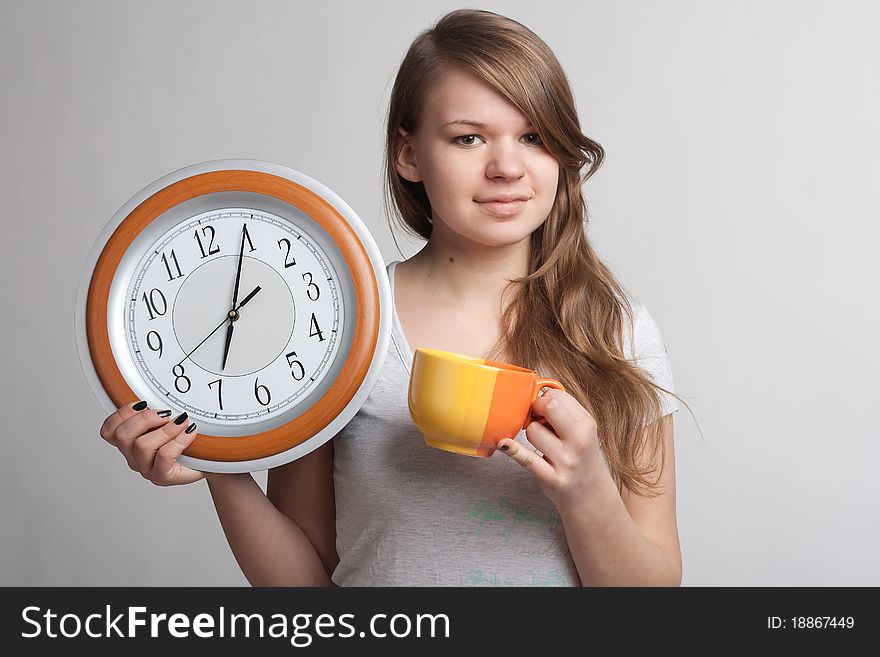 Portrait of a girl with a cup and a clock