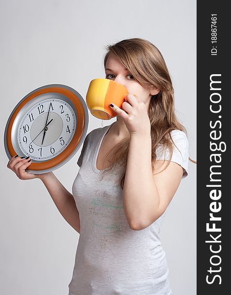 Portrait of a girl with a cup and a clock
