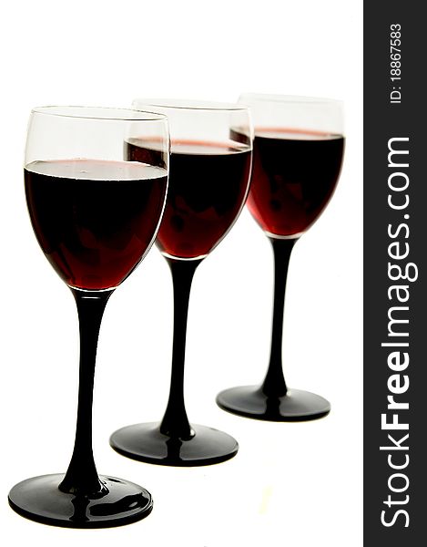 Red wine in glass glasses on the white isolated background