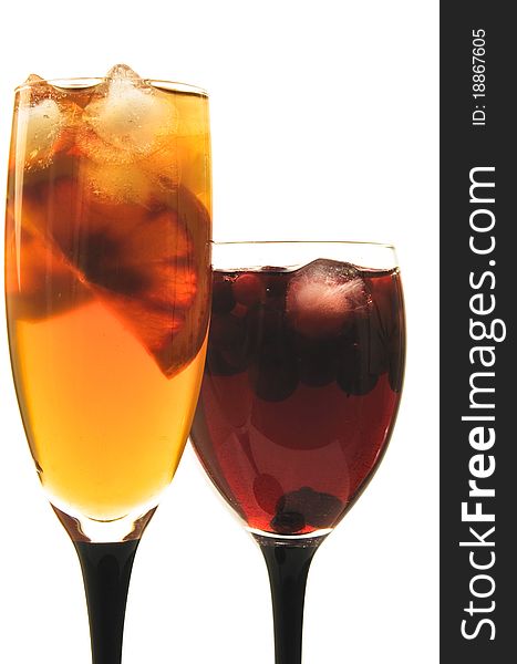 Fruit cocktail in glass glasses on the white isolated background