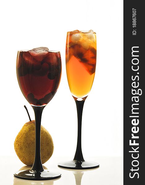 Fruit cocktail in glass glasses on the white isolated background