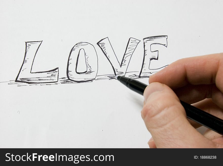 Artist writing LOVE on paper