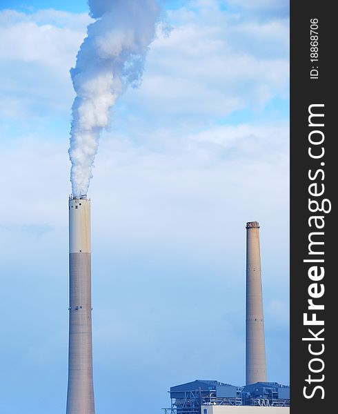 Smokestacks of power station on sky background