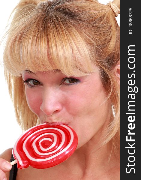 Middle aged woman enjoying a lollipop. Middle aged woman enjoying a lollipop