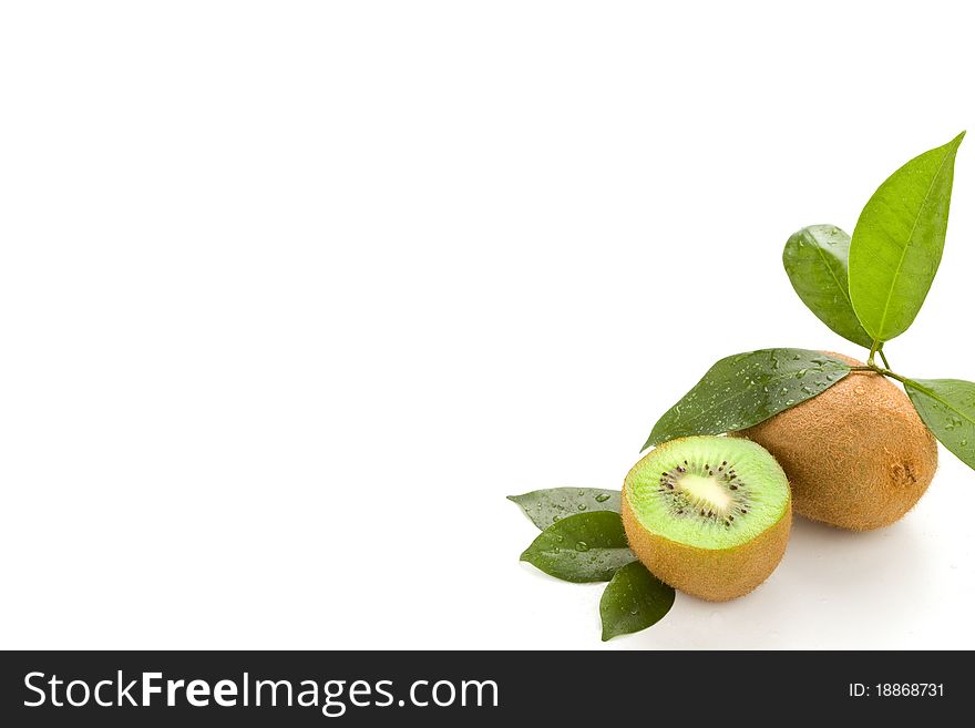Photo of cutted kiwi with green leaves on white isolated background