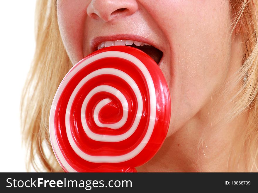 Blond woman licks red round lollipop. Blond woman licks red round lollipop